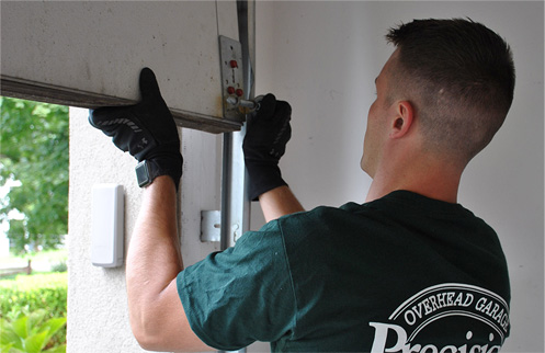 Technician Repairing Garage Door